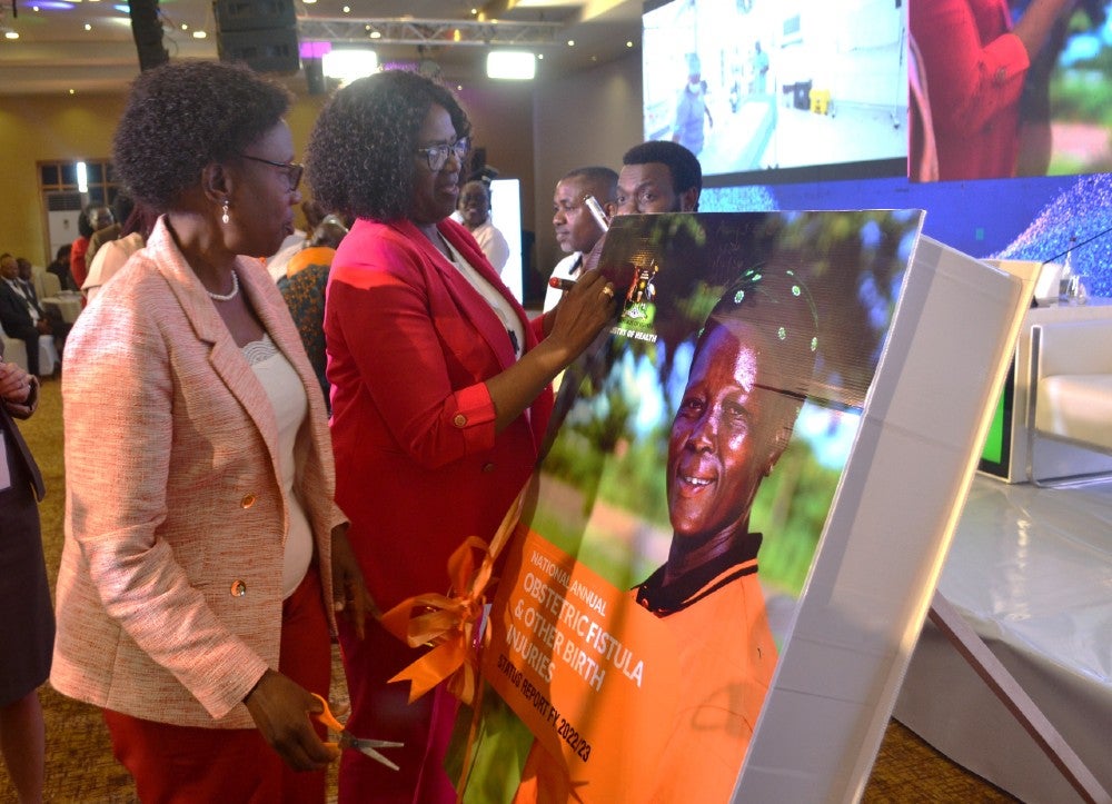 UNFPA Uganda Representative Ms Gift Malunga launching the key documents during the Safe Motherhood Conference. Looking on is Hon. Jane Ruth Aceng, Minister of Health. PHOTO: UNFPA/Evelyn Matsamura Kiapi.