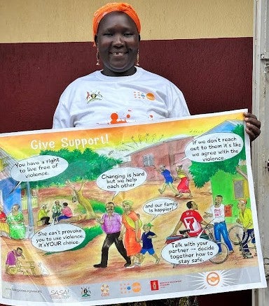 Paska Alobo holding a poster message of giving support to the survivors of SGBV and other communities in need of assistance. PHOTO: UNFPA/Cinderella Anena. 
