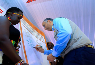 UNFPA Uganda Deputy Representative Me Daniel Alemu signs the commitment board during the launch of the ADA II project in Moroto