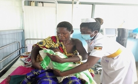 A midwife helping Ayorwoth to breastfeed her baby at Nebbi Hospital. Photo: UNFPA Uganda/Samuel Okiror